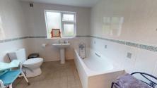 Large, fully tiled bathroom with walk-in shower